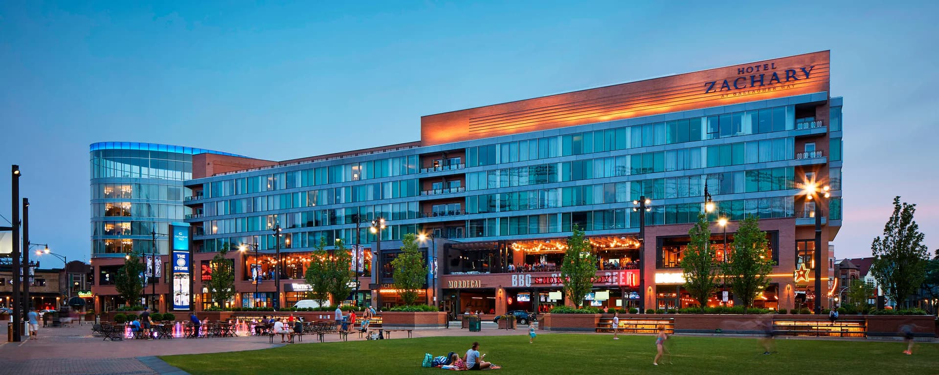 Hotel Zachary at dusk, facing the plaza at Gallagher Way